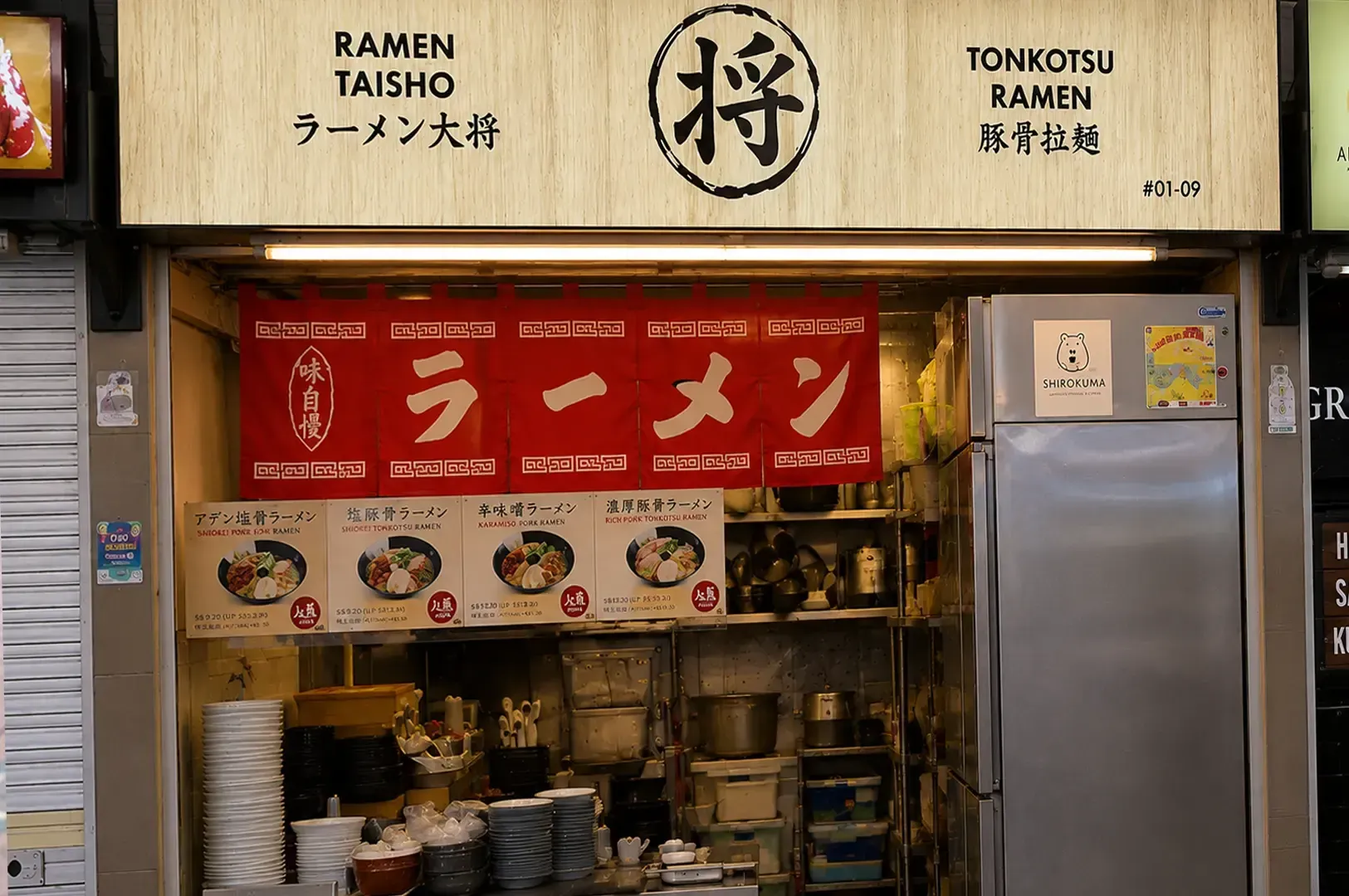Ramen Taisho food stall counter featuring wooden signage reading