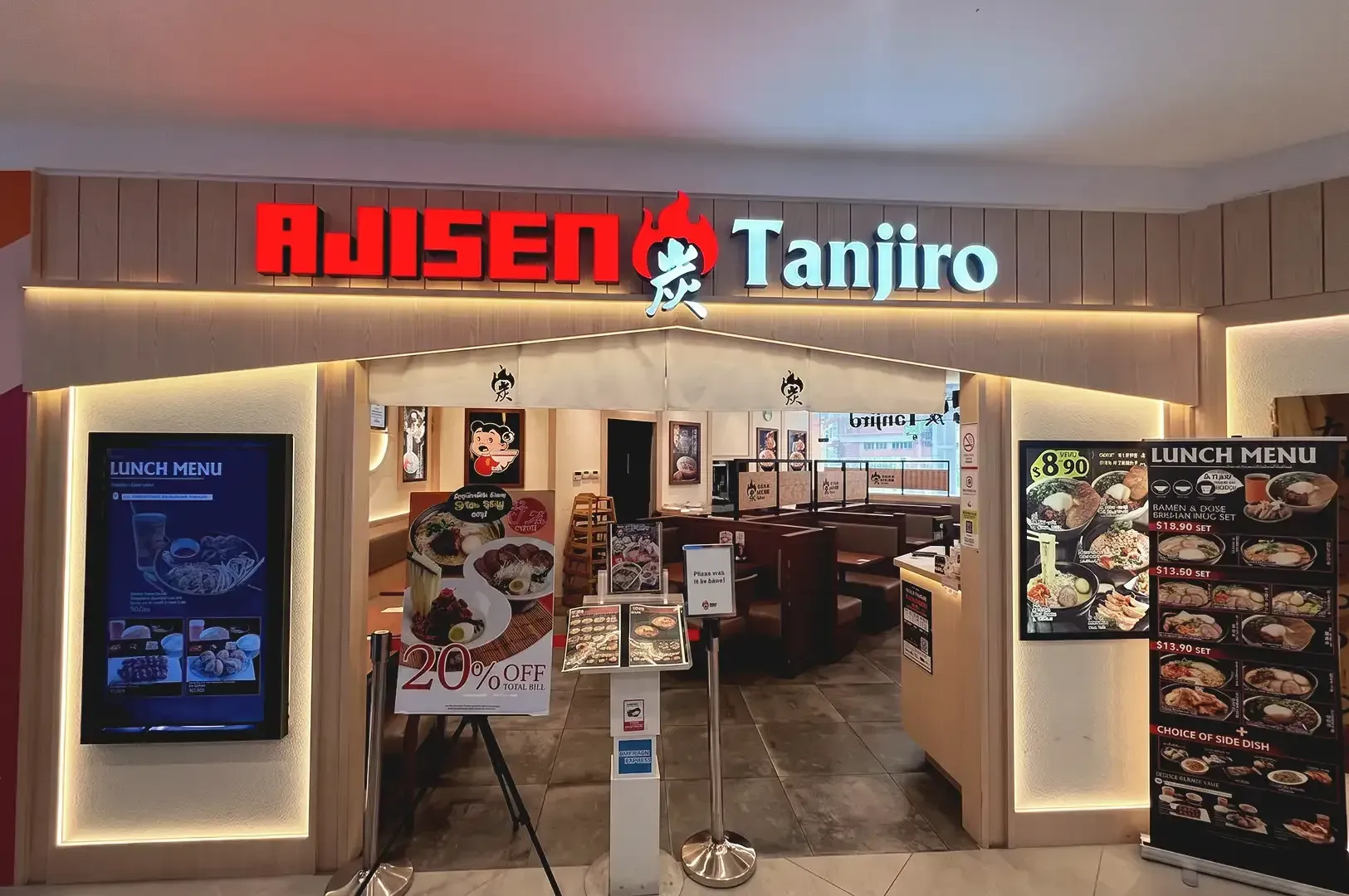 A view of Ajisen Tanjiro store with slightly visible interior and menu posters displayed outside of store