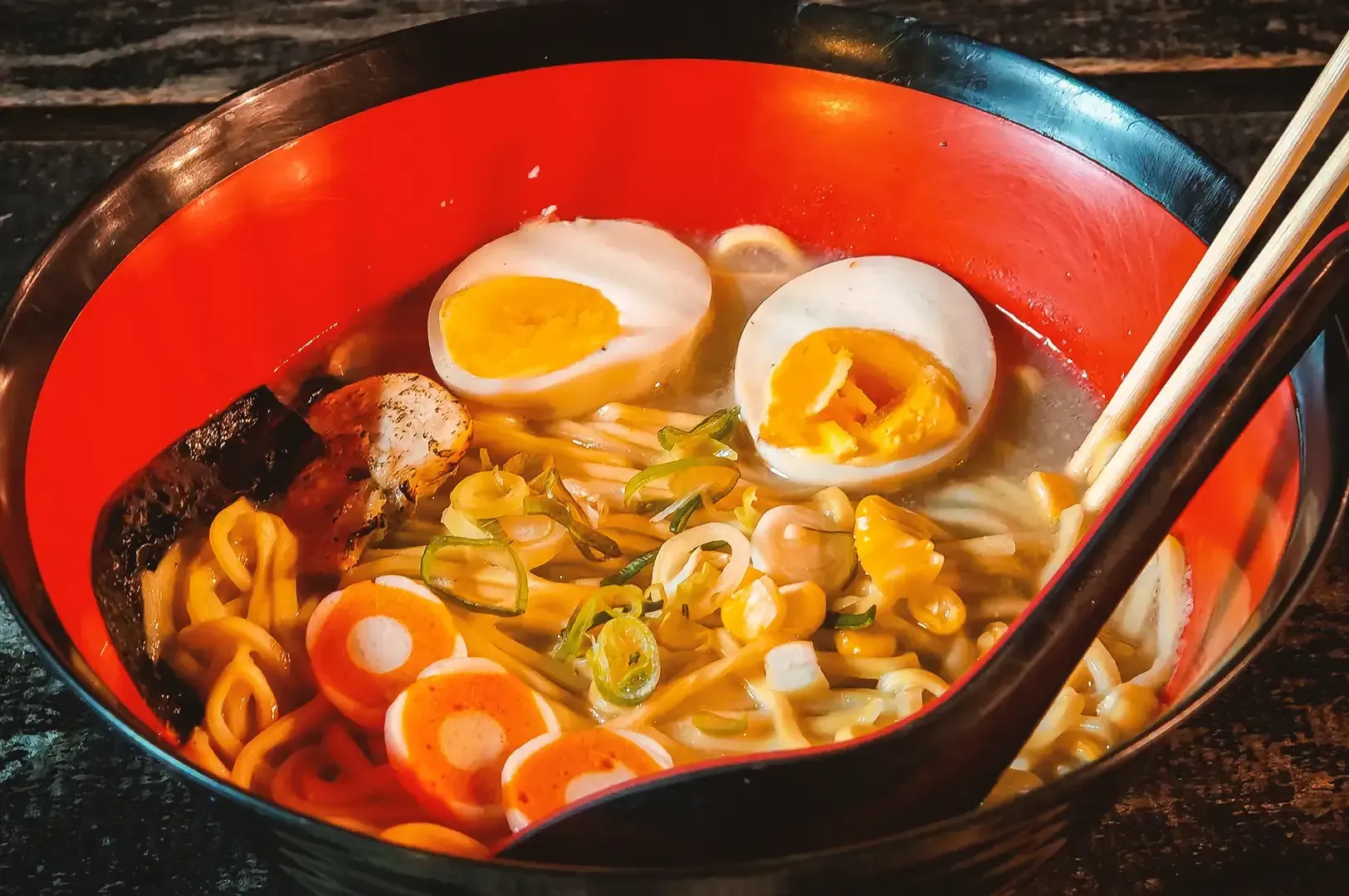 Bowl of ramen combined with corn, two eggs, seaweed and bits of pork meat