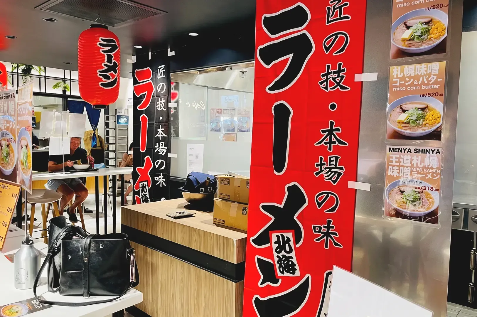 Interior of Sapporo Ramen Miharu with visible red Japanese inspired decorations
