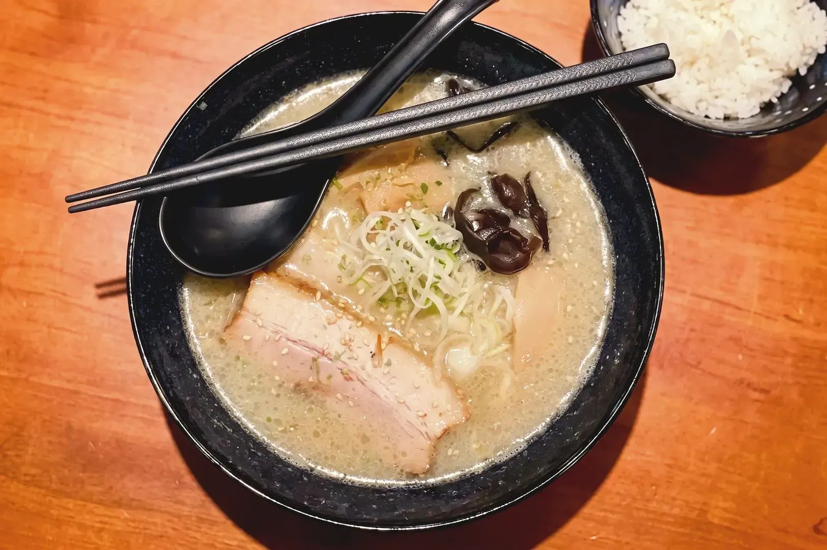 Top view of Awase ramen topped with veggies and pork meat