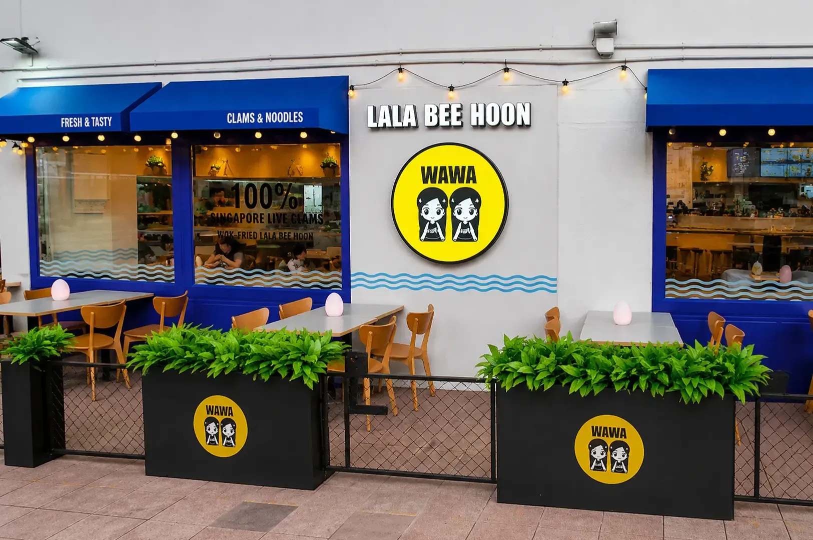 Wawa Lala Bee Hoon restaurant with blue and yellow branding, outdoor seating area with planters