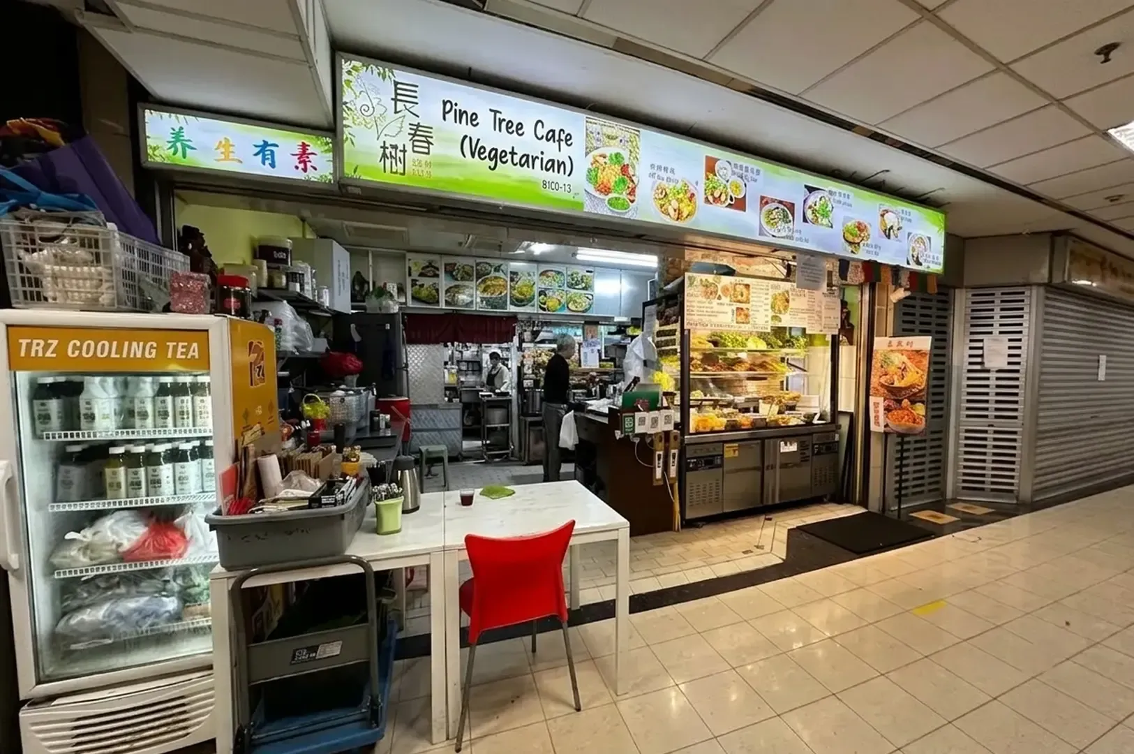 Pine Tree Cafe vegetarian restaurant storefront with food display counter and menu signage