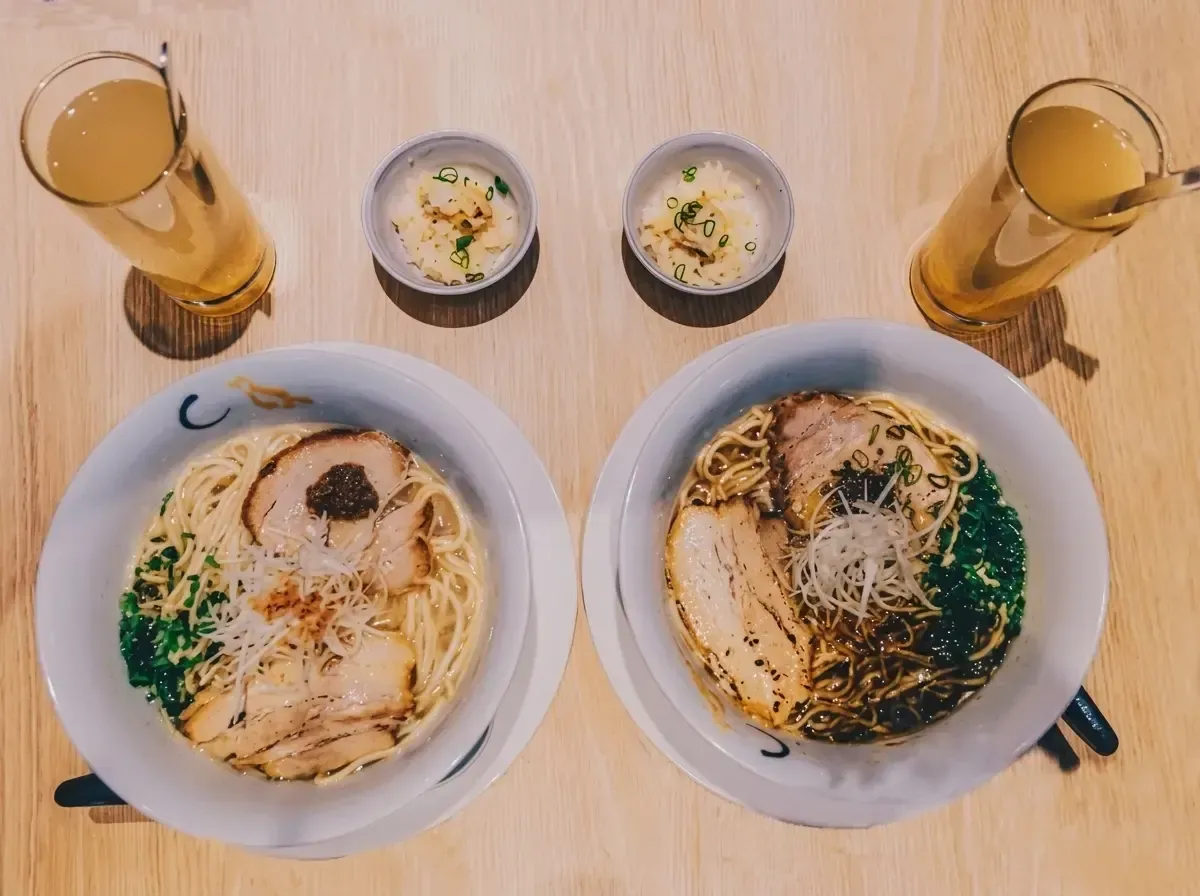 Dining area of Menbaka Fire Ramen showing empty wooden tables under a glowing