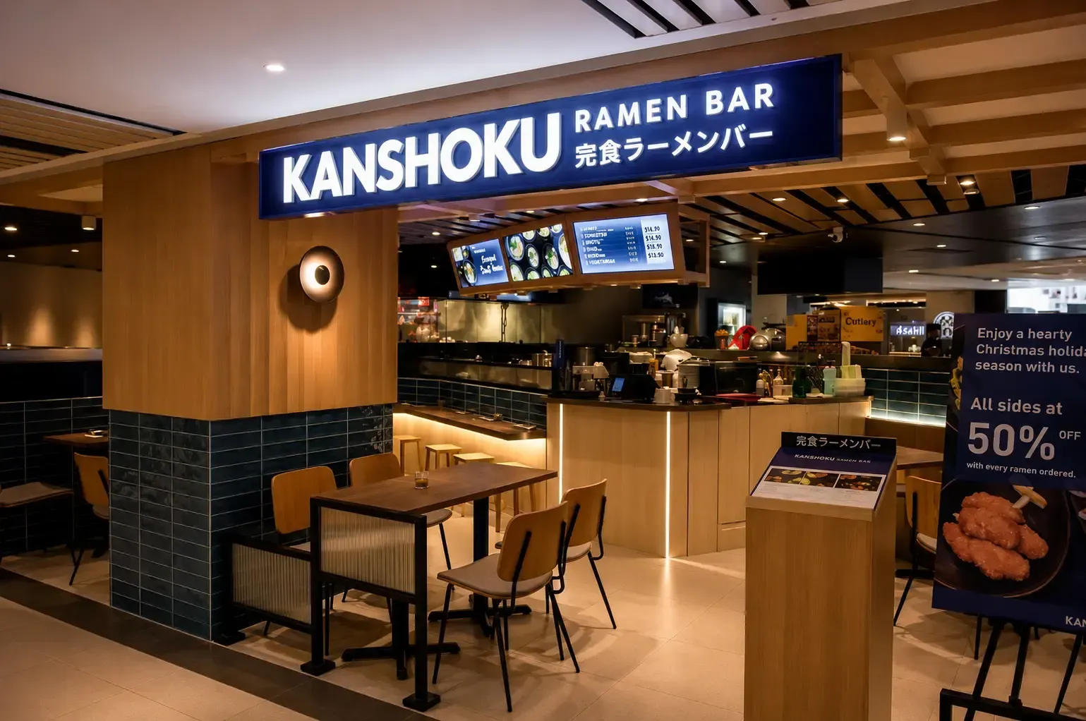 Modern storefront exterior of Kanshoku Ramen Bar with a glowing blue neon sign, warm wooden paneling, and an ordering counter.