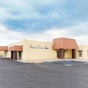 A large building with a parking lot in front of it