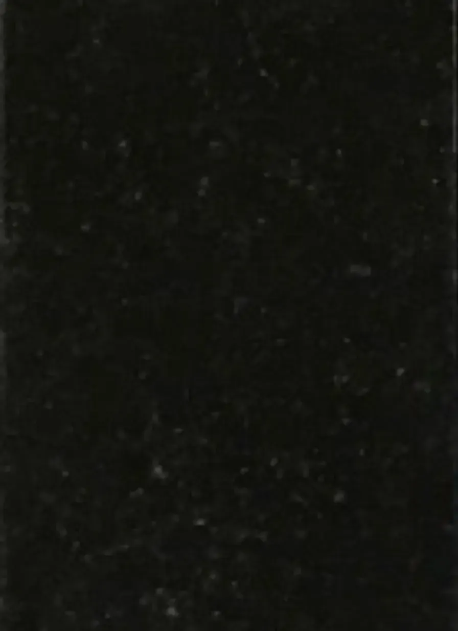 A close up of a black surface with a grainy texture.