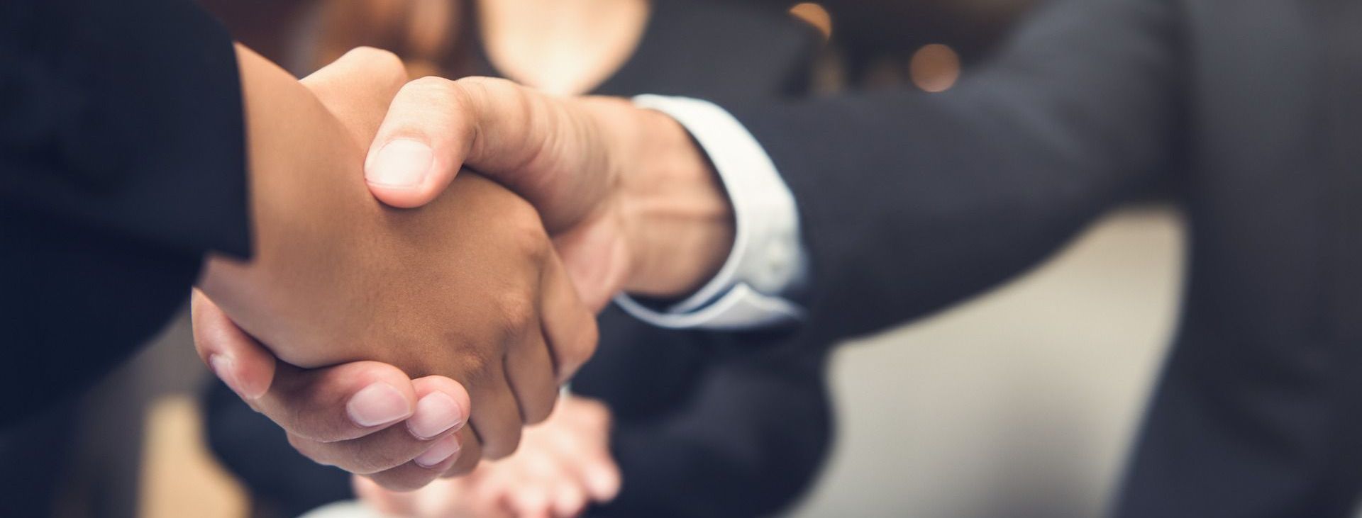 A group of people are shaking hands in a room.