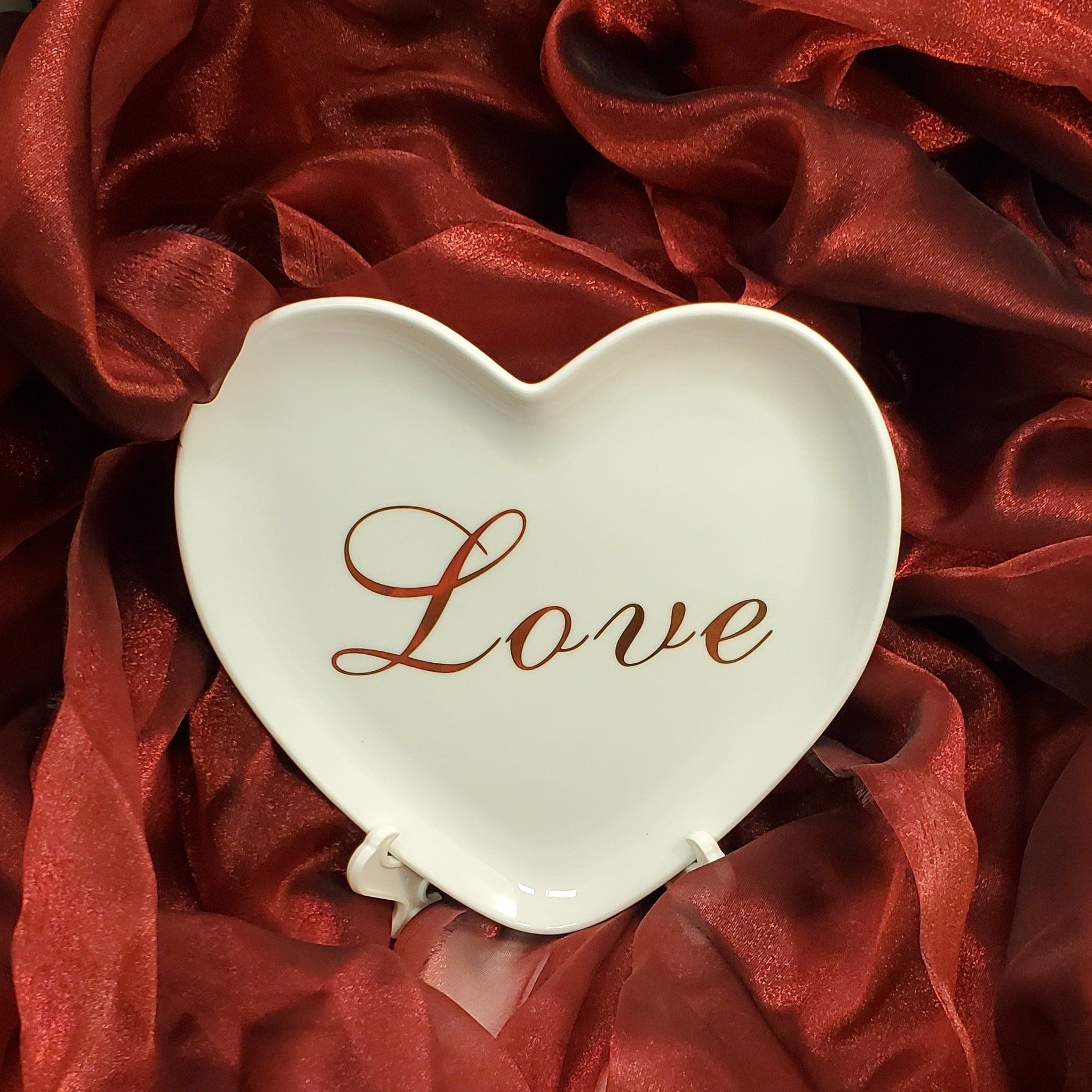 Heart shape dish with love written in the center in gold