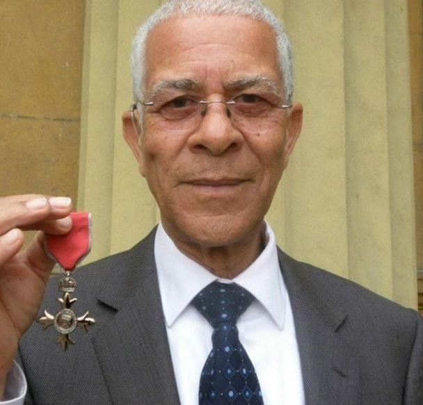 Bert proudly holding his MBE received from Prince Charles