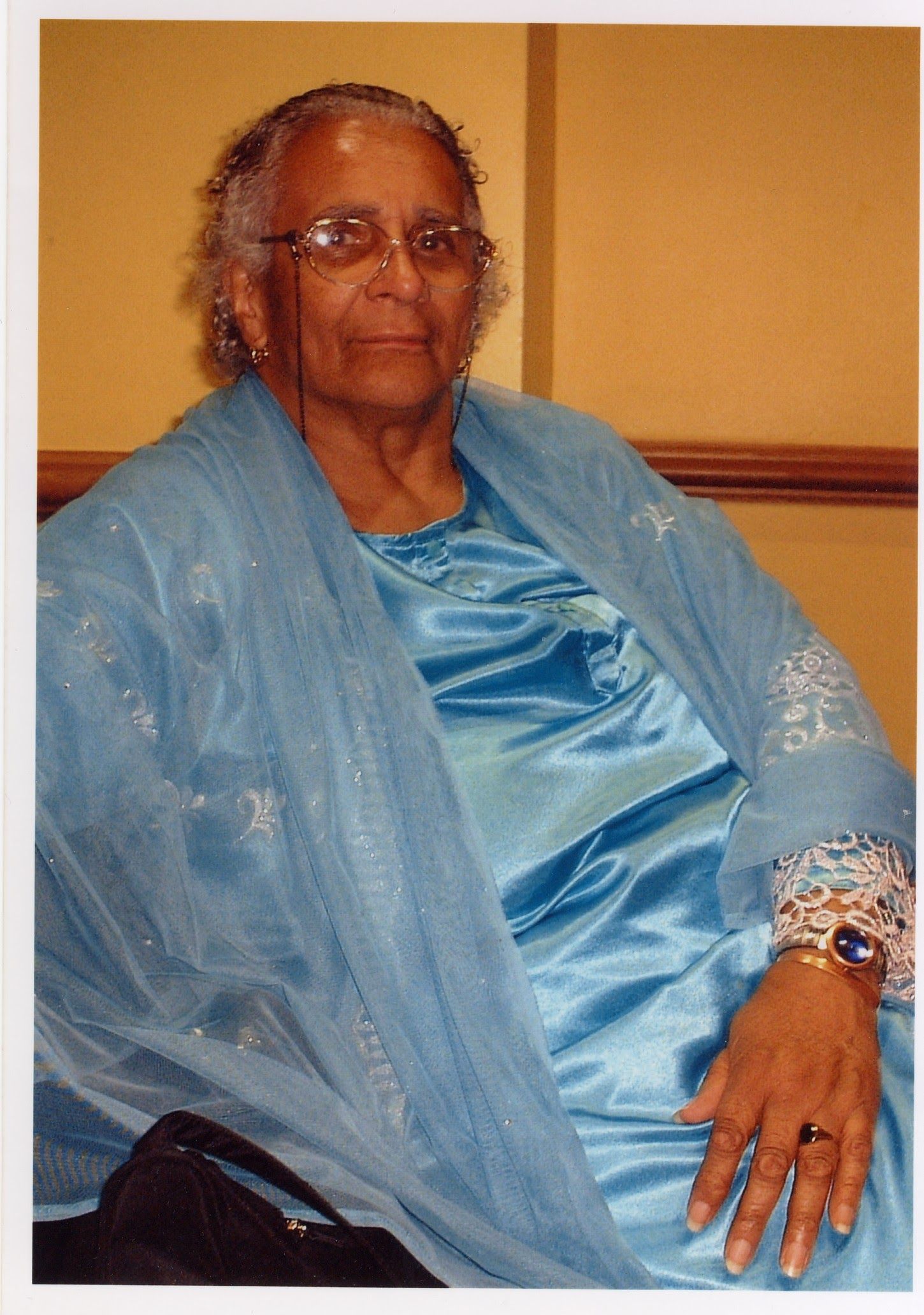 Portrait of Faith Matyszak-Gander seated and wearing blue.