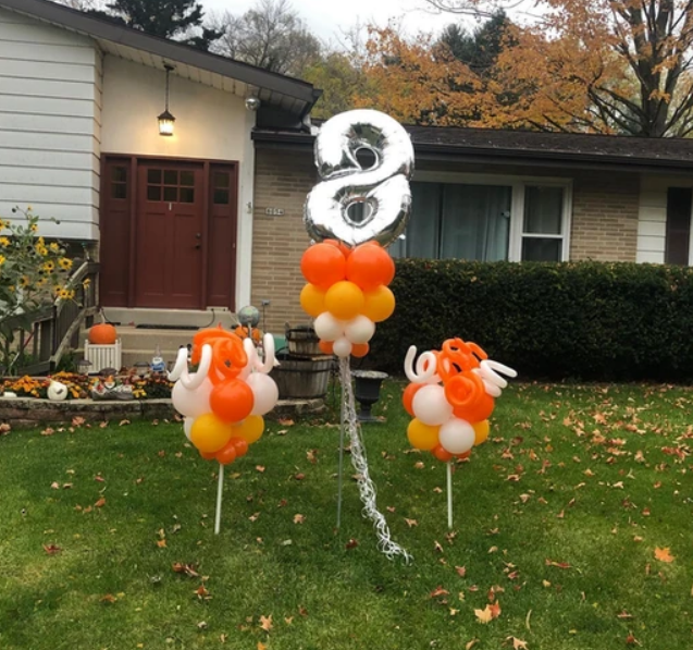 A bunch of balloons with the number 2 on them