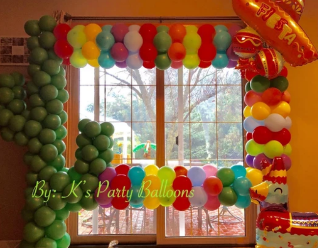 A window is decorated with balloons by ks party balloons