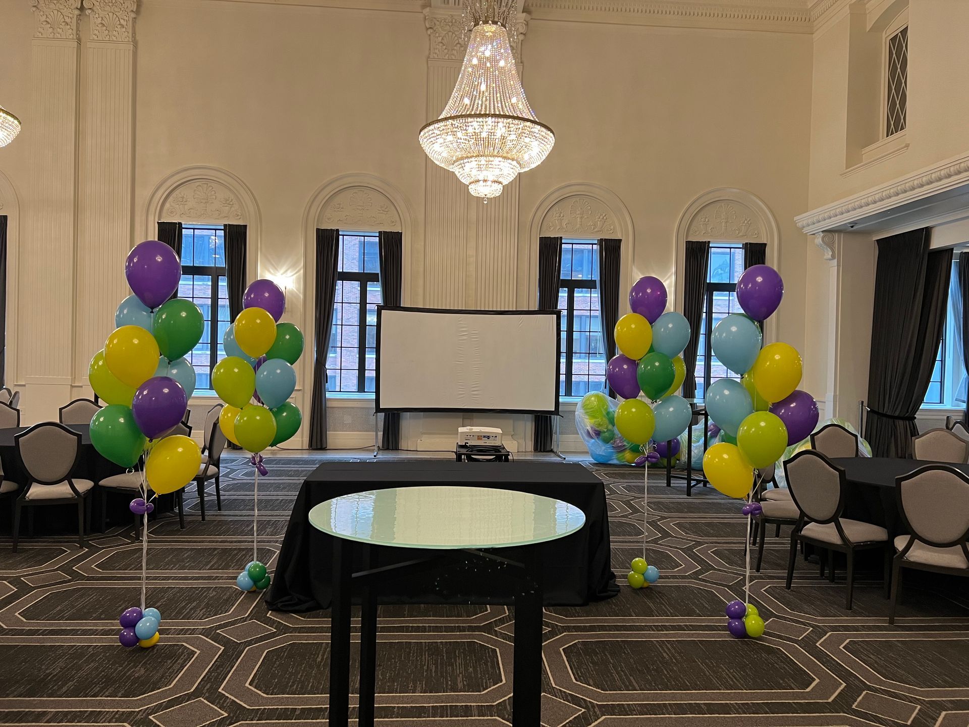 A large room decorated with balloons and a table.