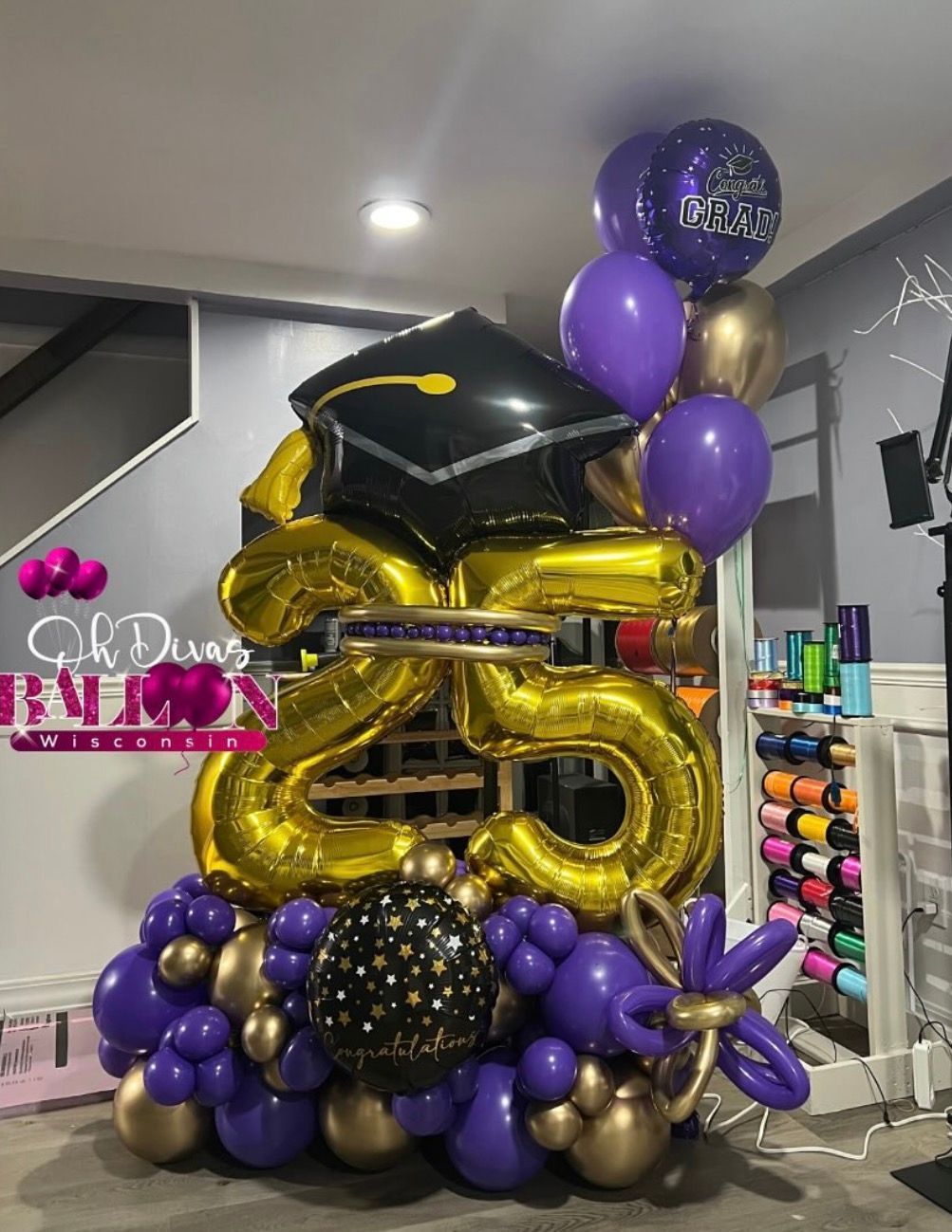 green corporate balloon arch
