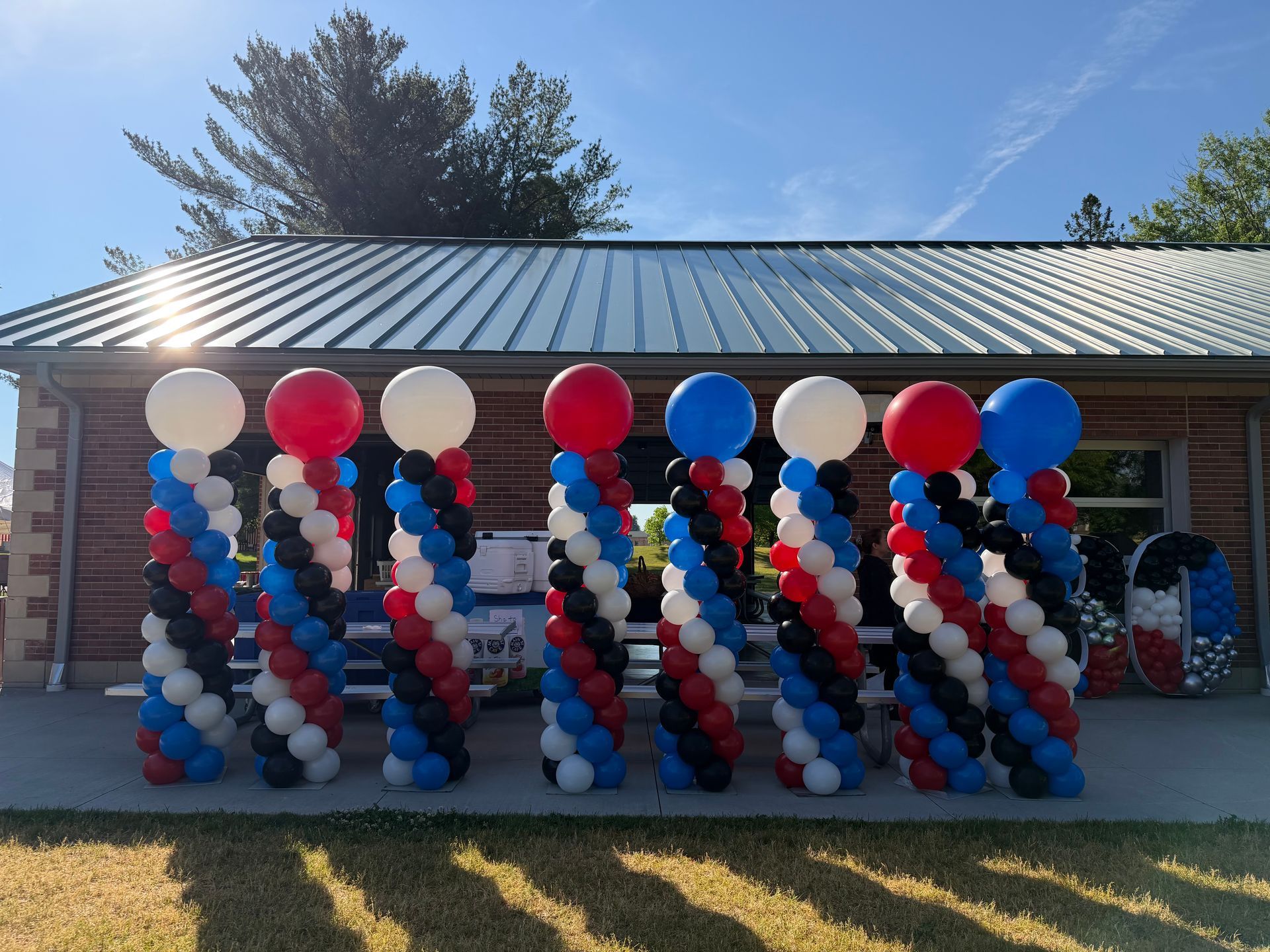 A hallway with two columns of balloons in the middle of it.