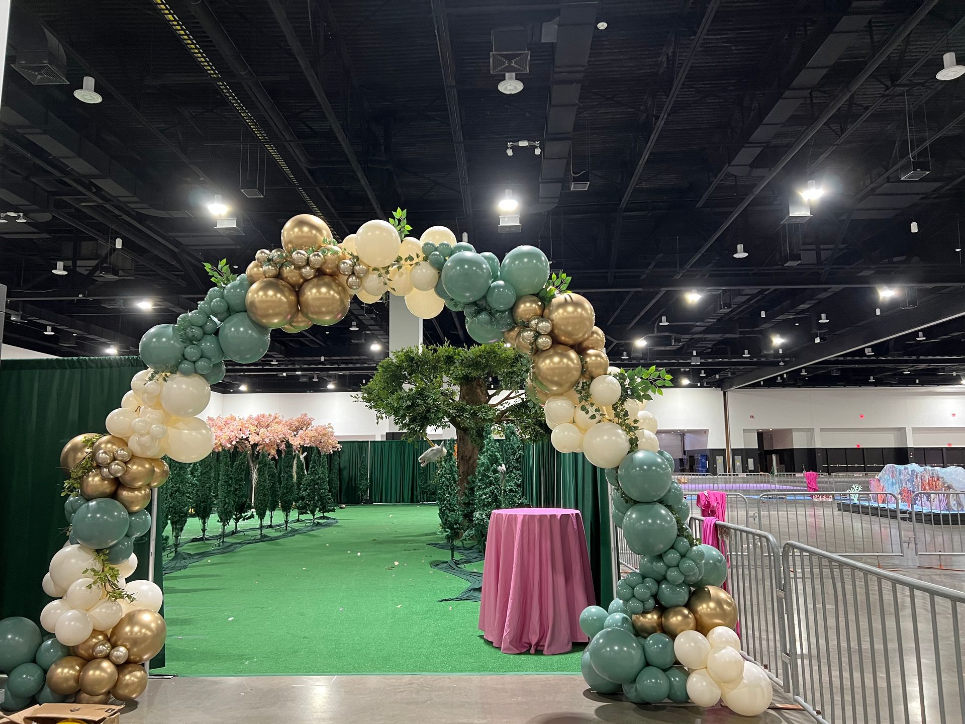 A large room filled with balloons and a table.
