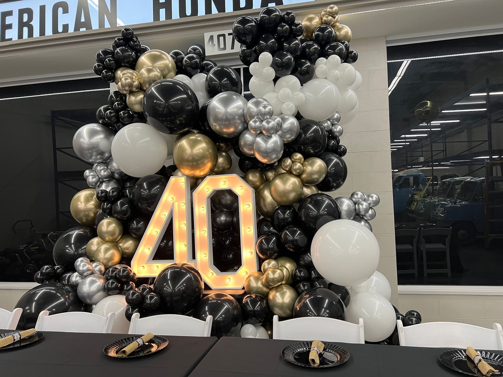 A table is decorated with balloons and a sign that says 40.