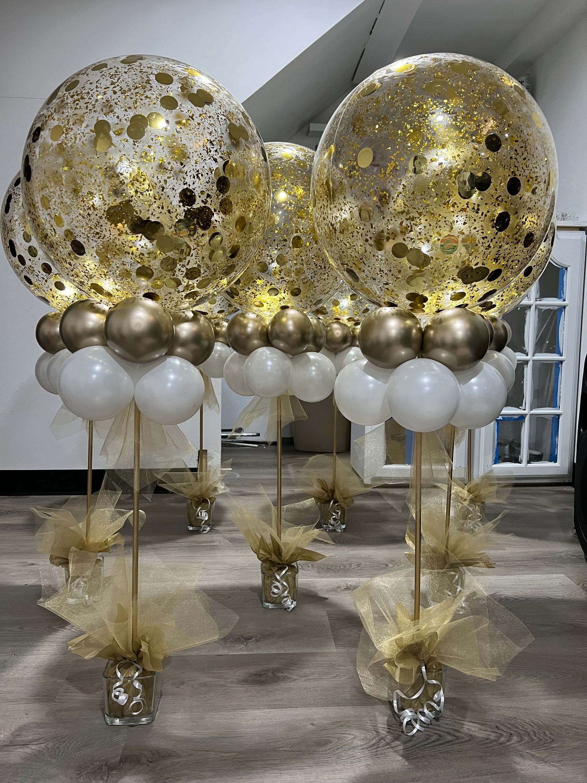 A bunch of balloons are sitting on top of each other in a room.