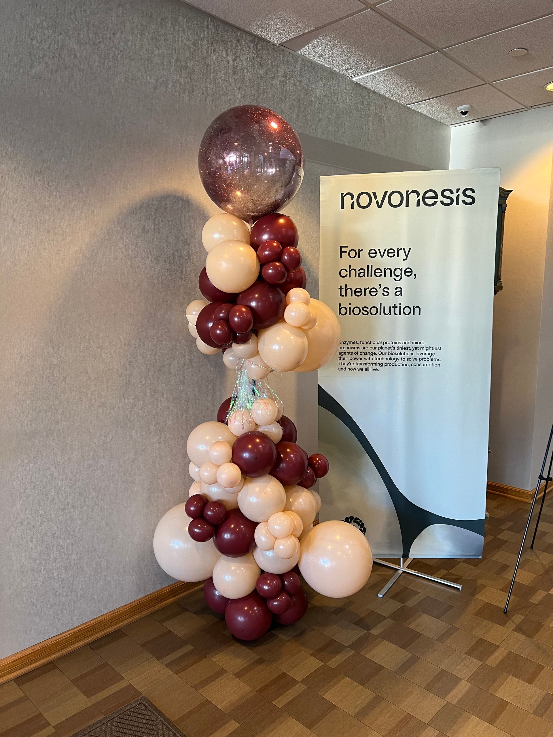 A bunch of balloons are stacked on top of each other in a room.