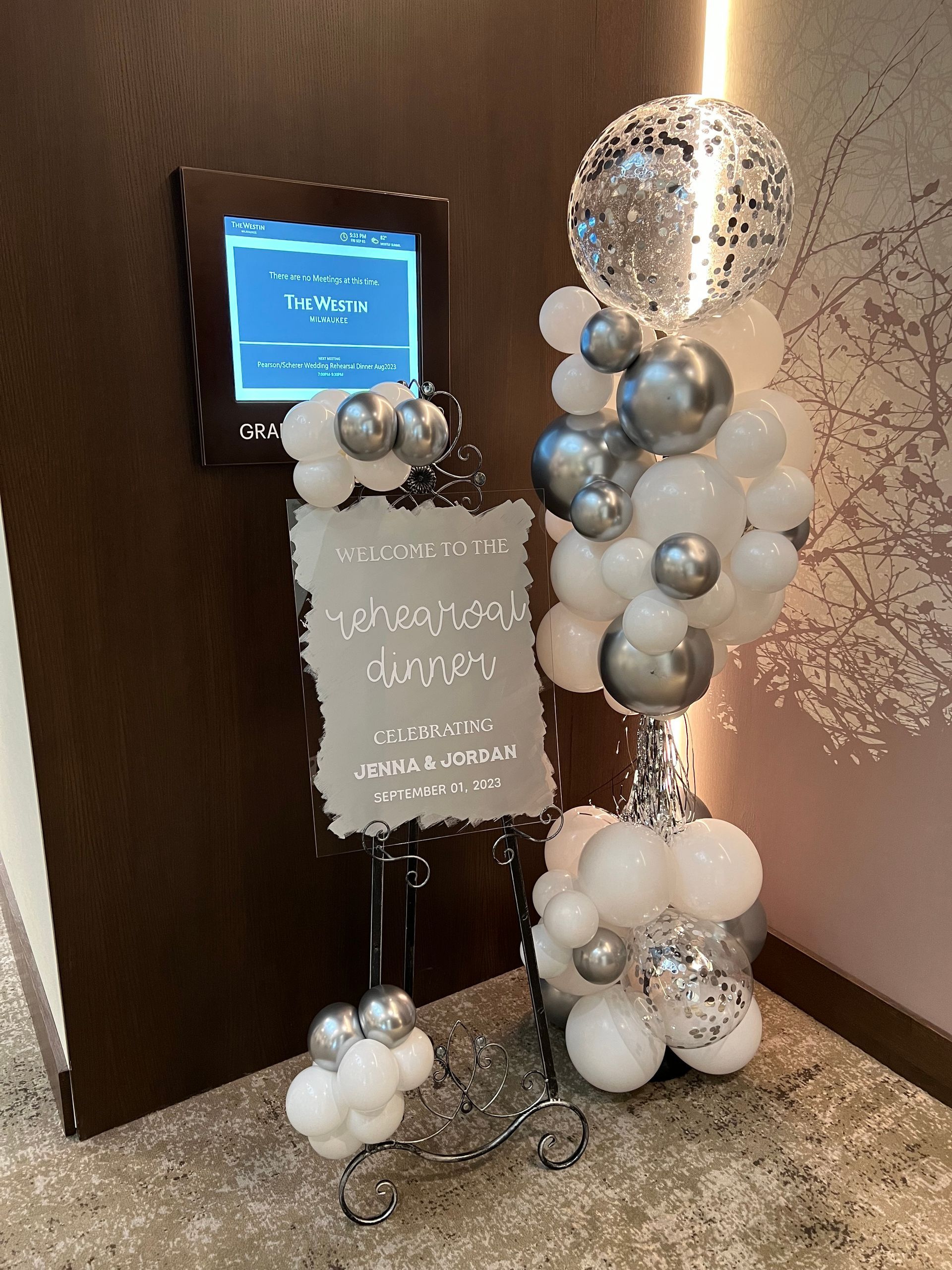 A display of balloons and a sign in a room.