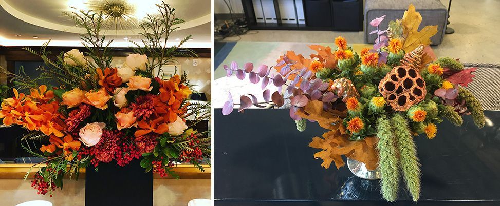 Two bouquets with red, orange, and green flowers and green leaves side by side