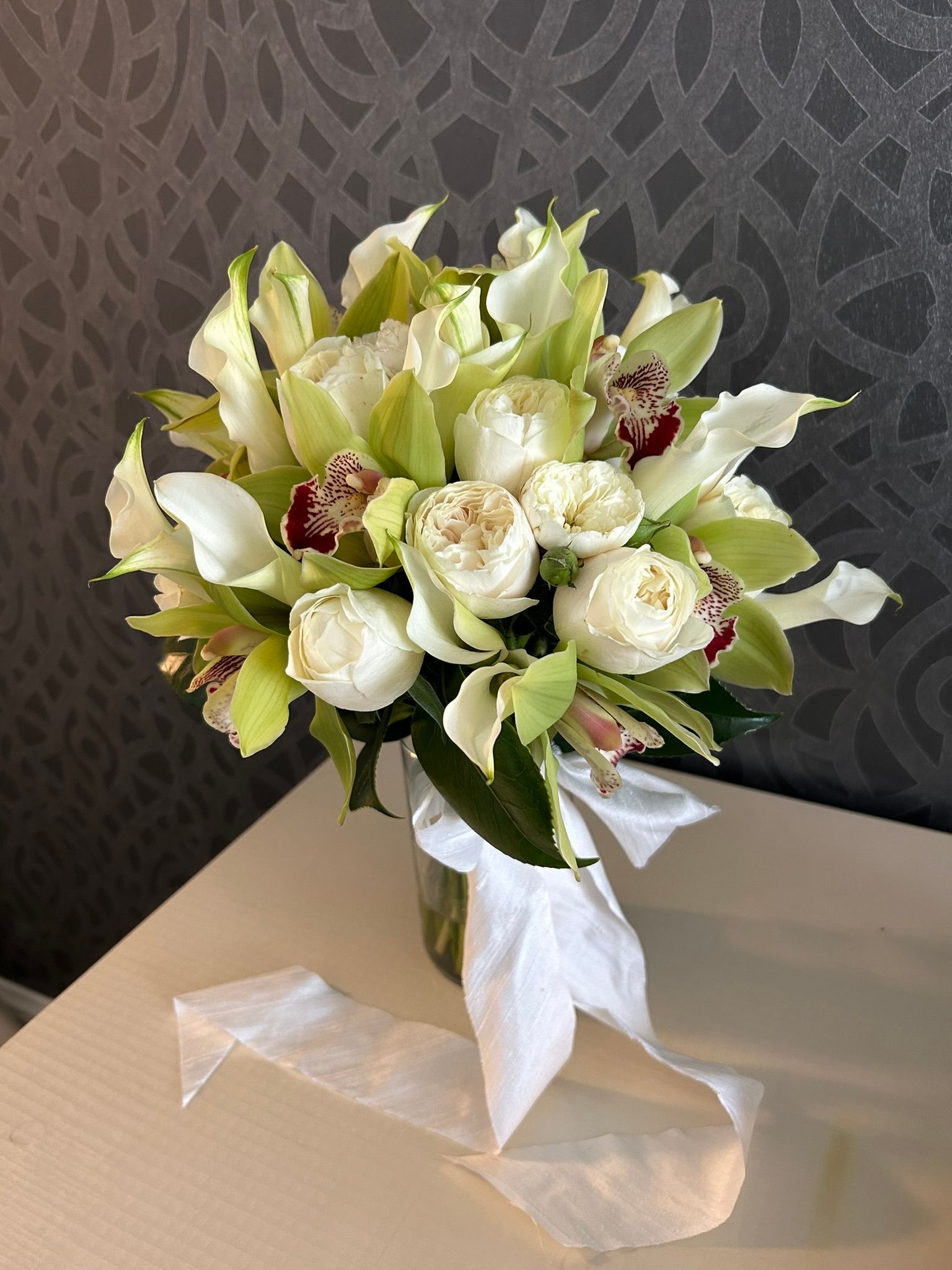 A bouquet of white flowers is sitting on a table.