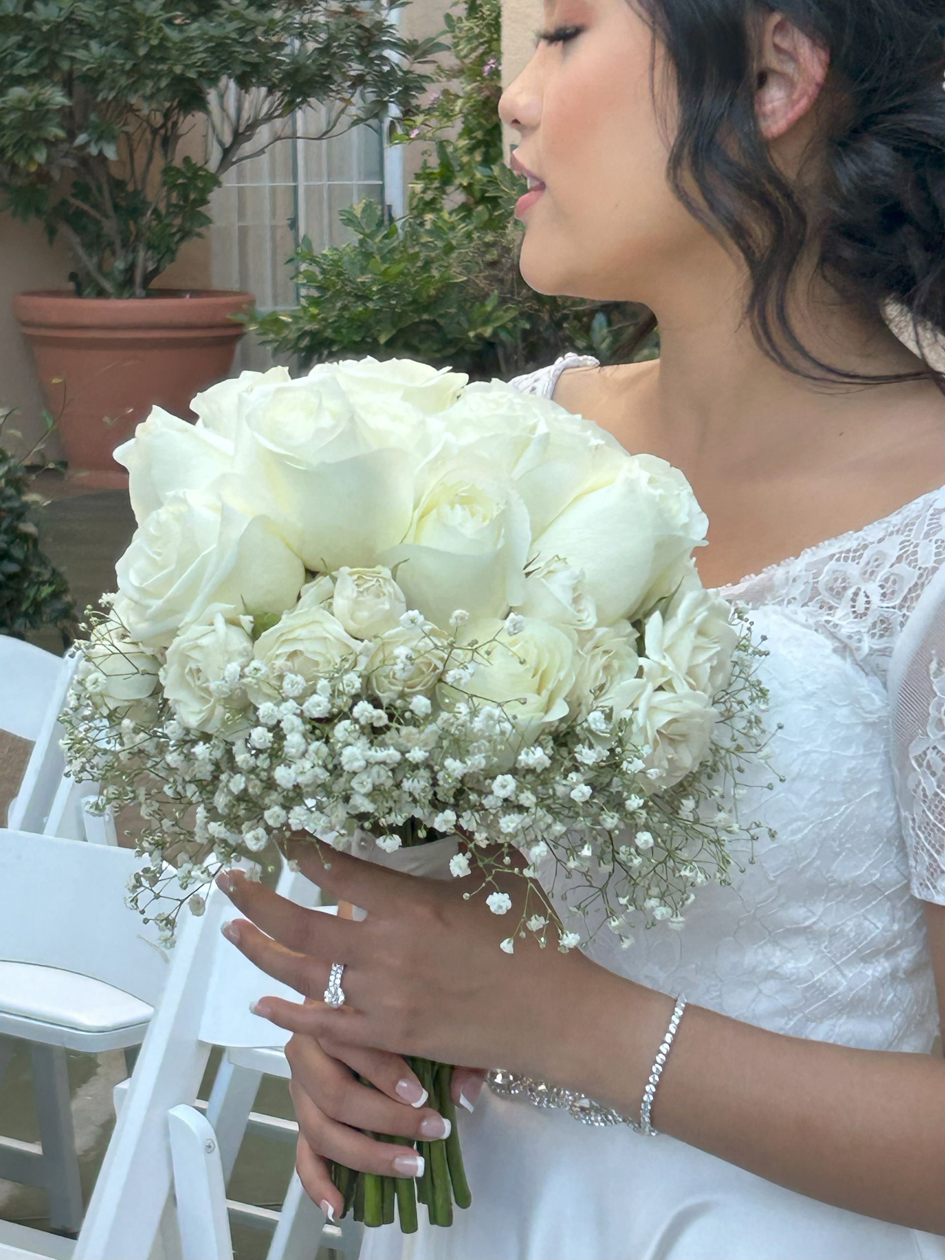 A modern bridal bouquet of white roses and baby 's breath