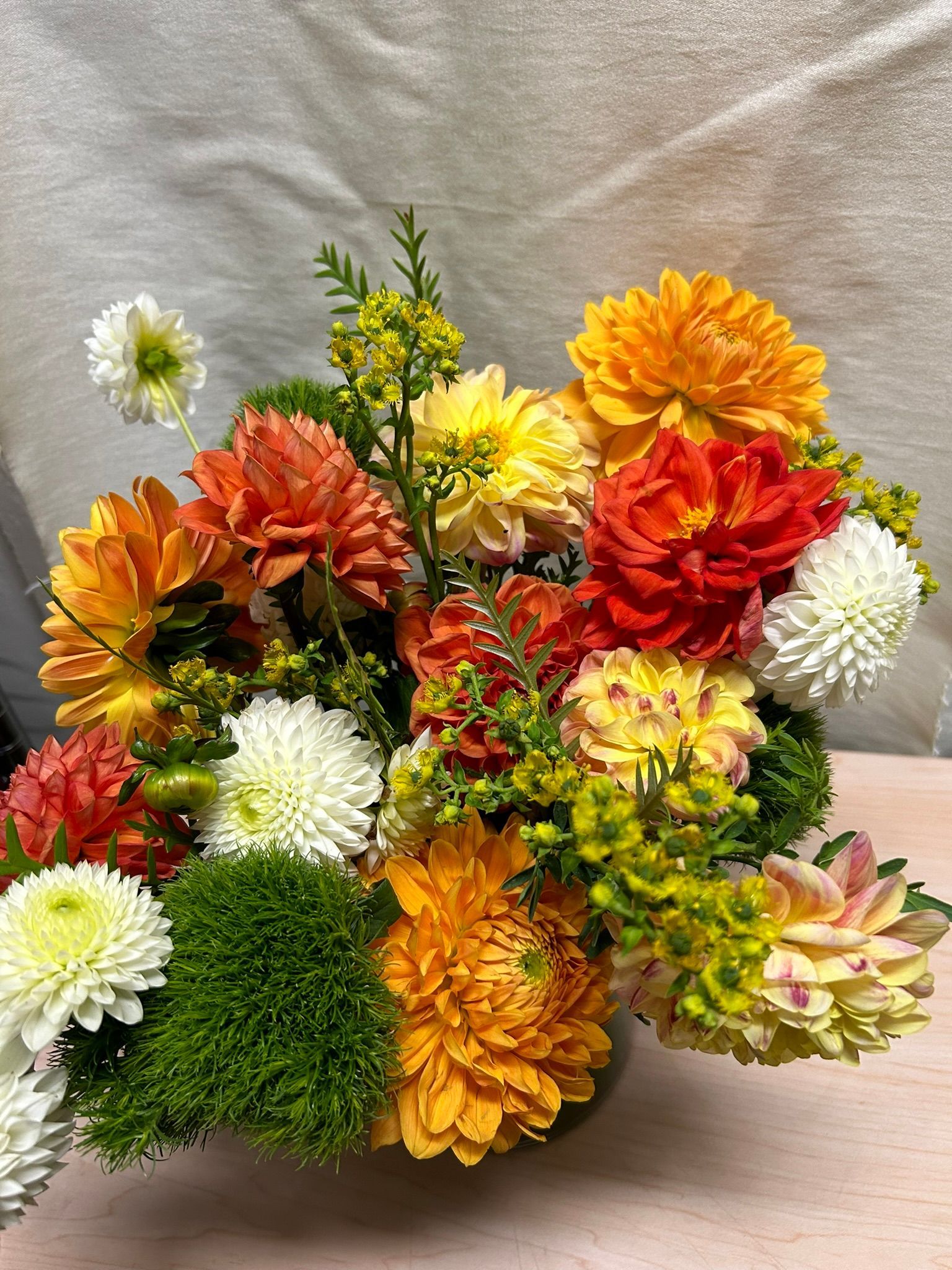 A vase filled with a variety of colorful flowers