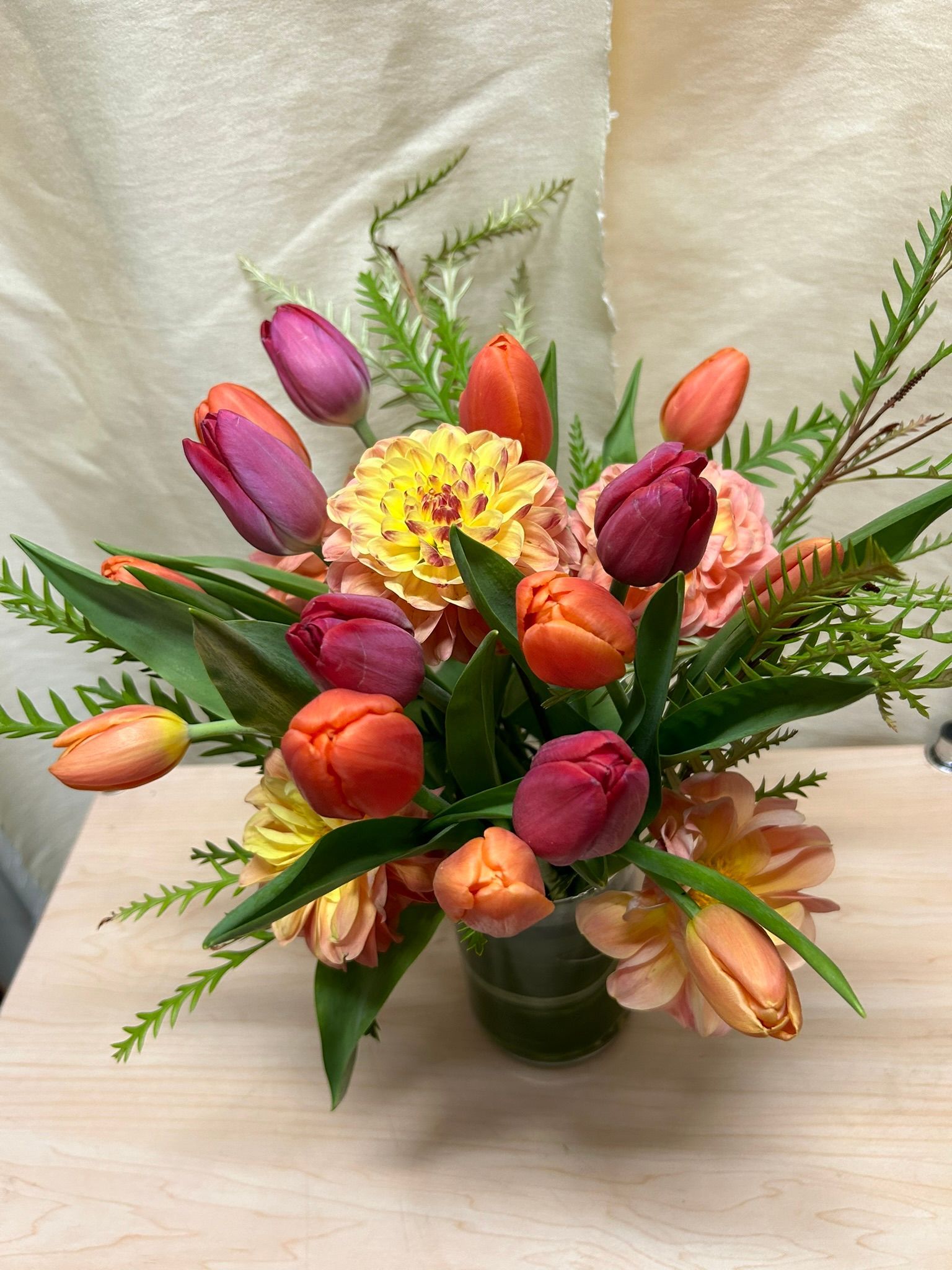 A vase of tulips and dahlias
