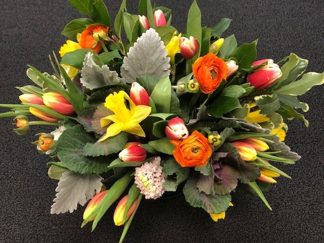 A bunch of flowers are sitting on a black surface