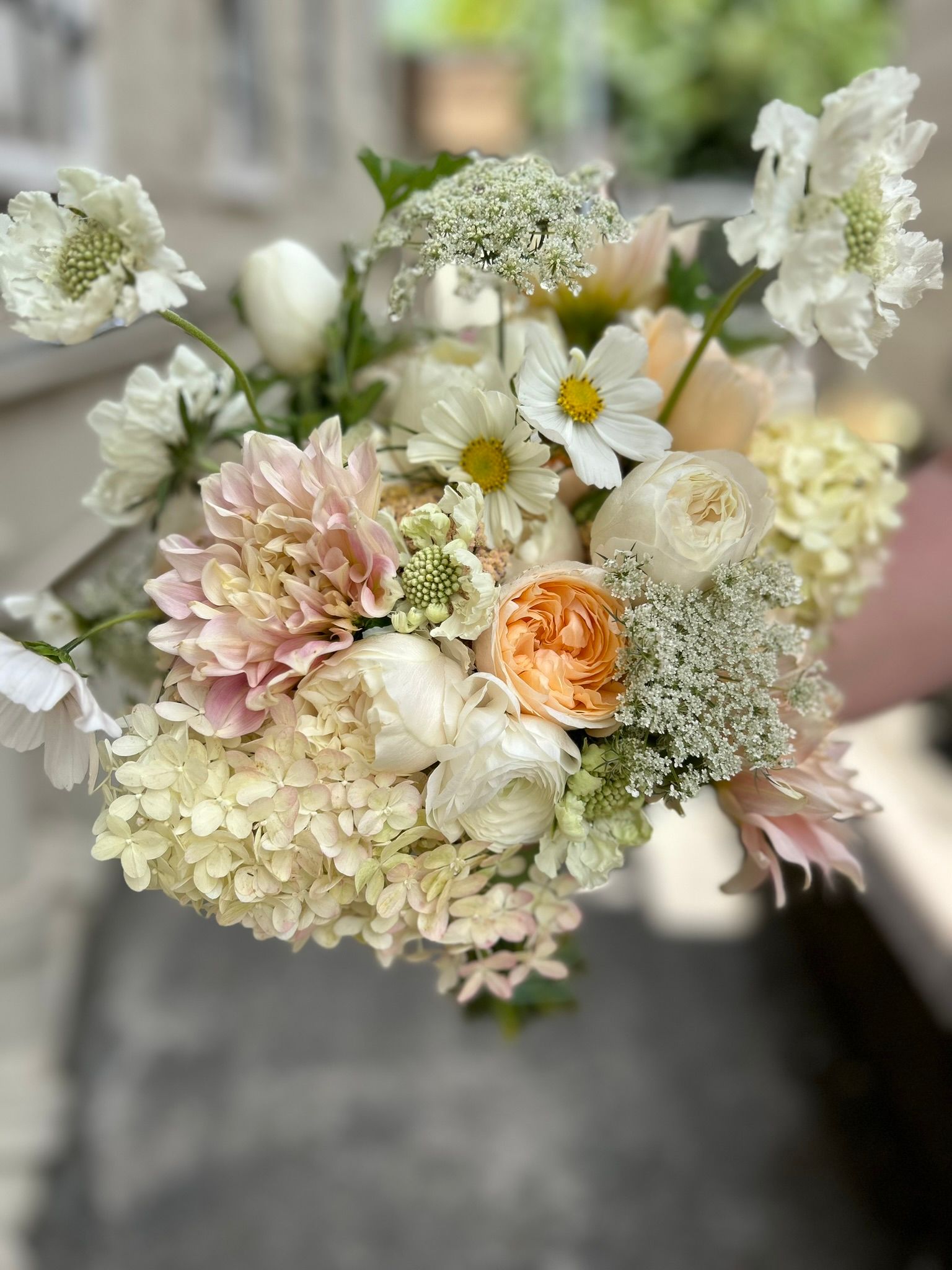 A lush summer bouquet with dahlias, cosmos, and garden roses