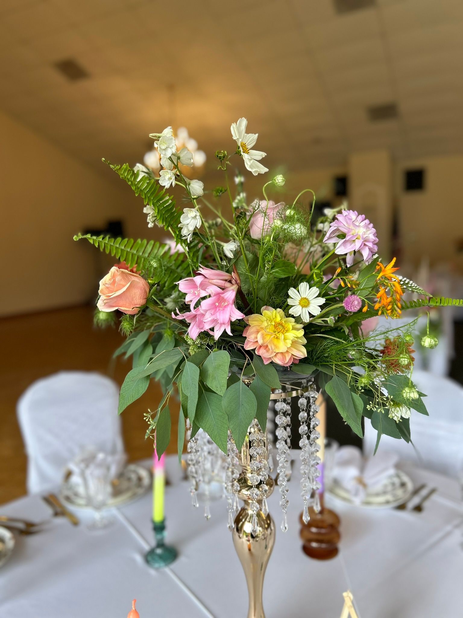 A tall elegant floral centerpiece with wildflowers