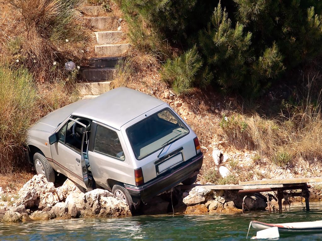 A car is stuck in the water near some stairs