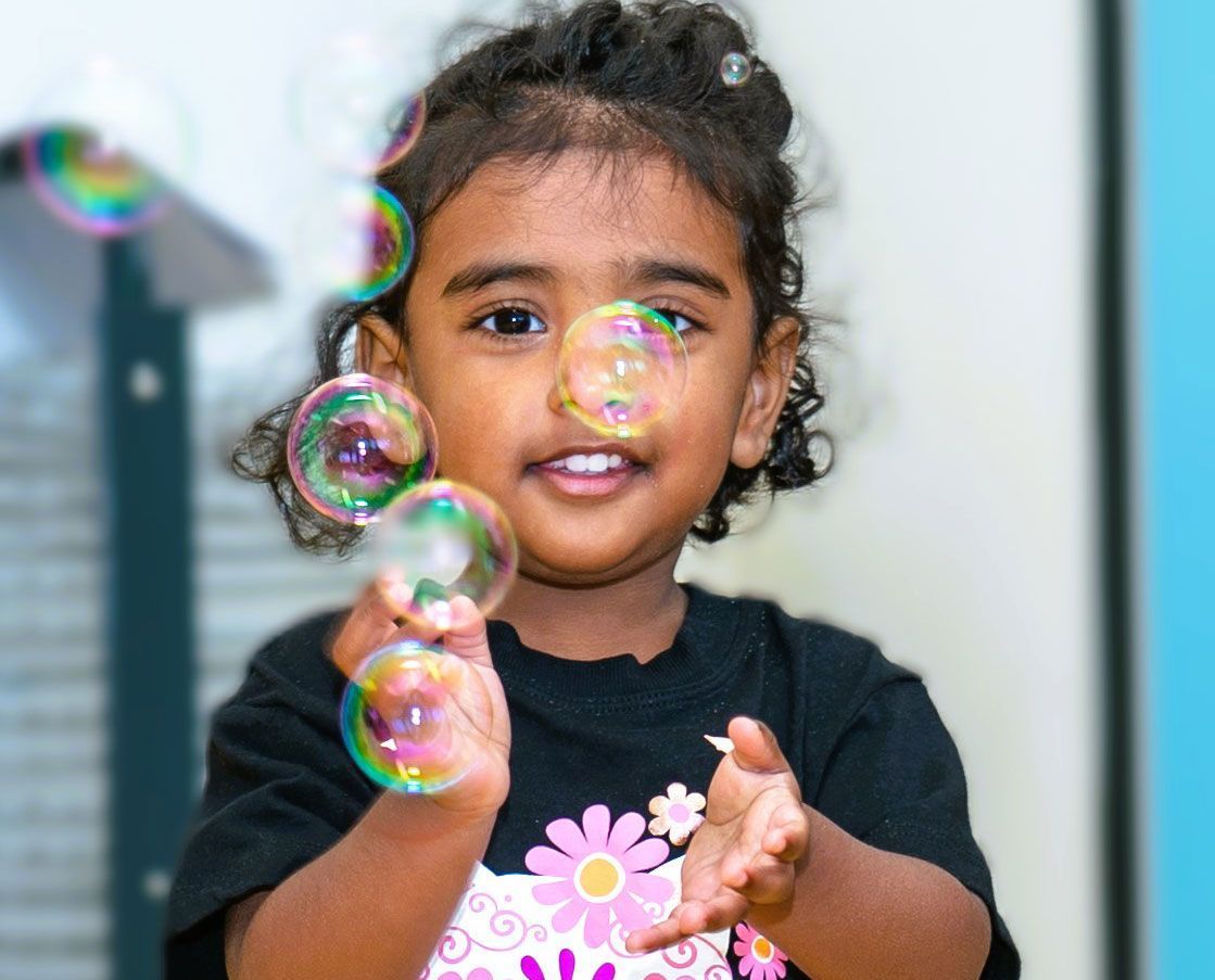 Smiling Toddler behing superimposed bubbles