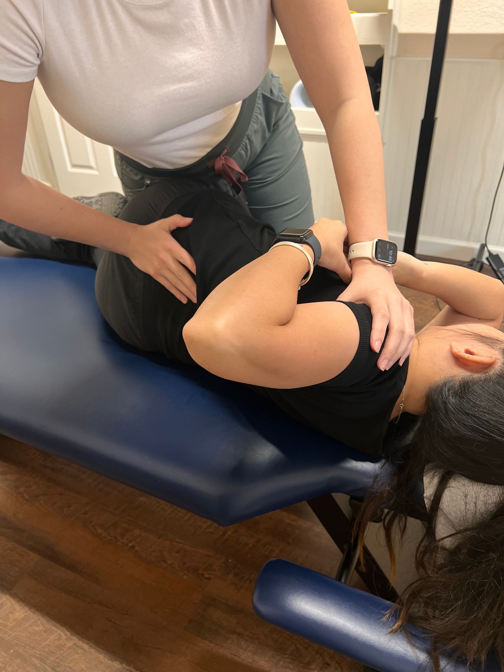 a man is laying on a bed getting a massage from a woman .