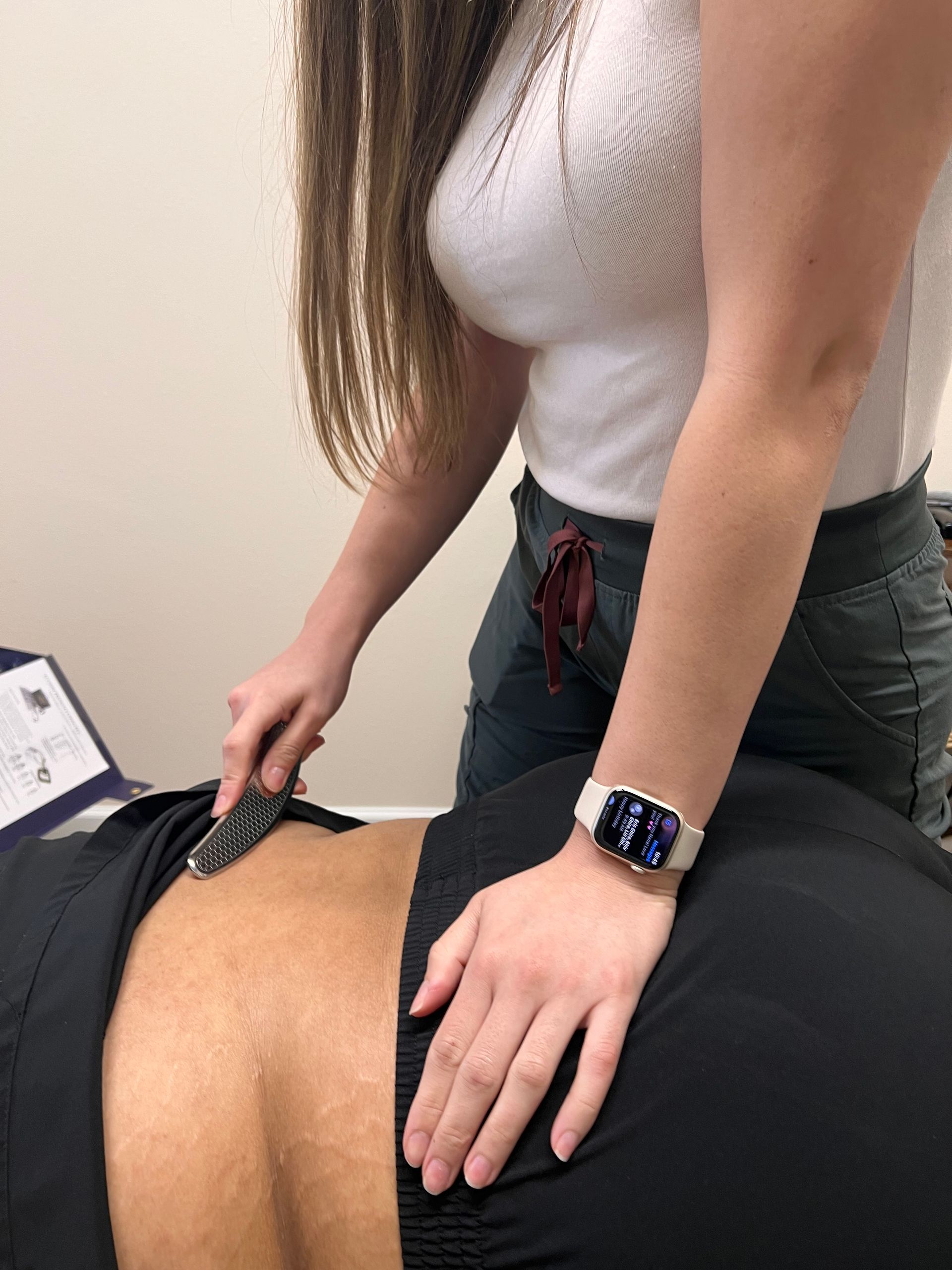 a man is laying on a bed getting a massage from a doctor .