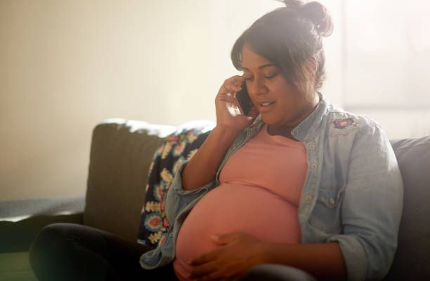 Expectant parent speaking with an adoption agency about pregnancy options.