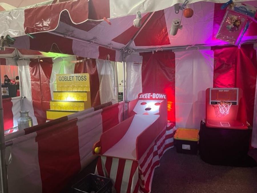 A tent with a shuffle bowl game inside of it