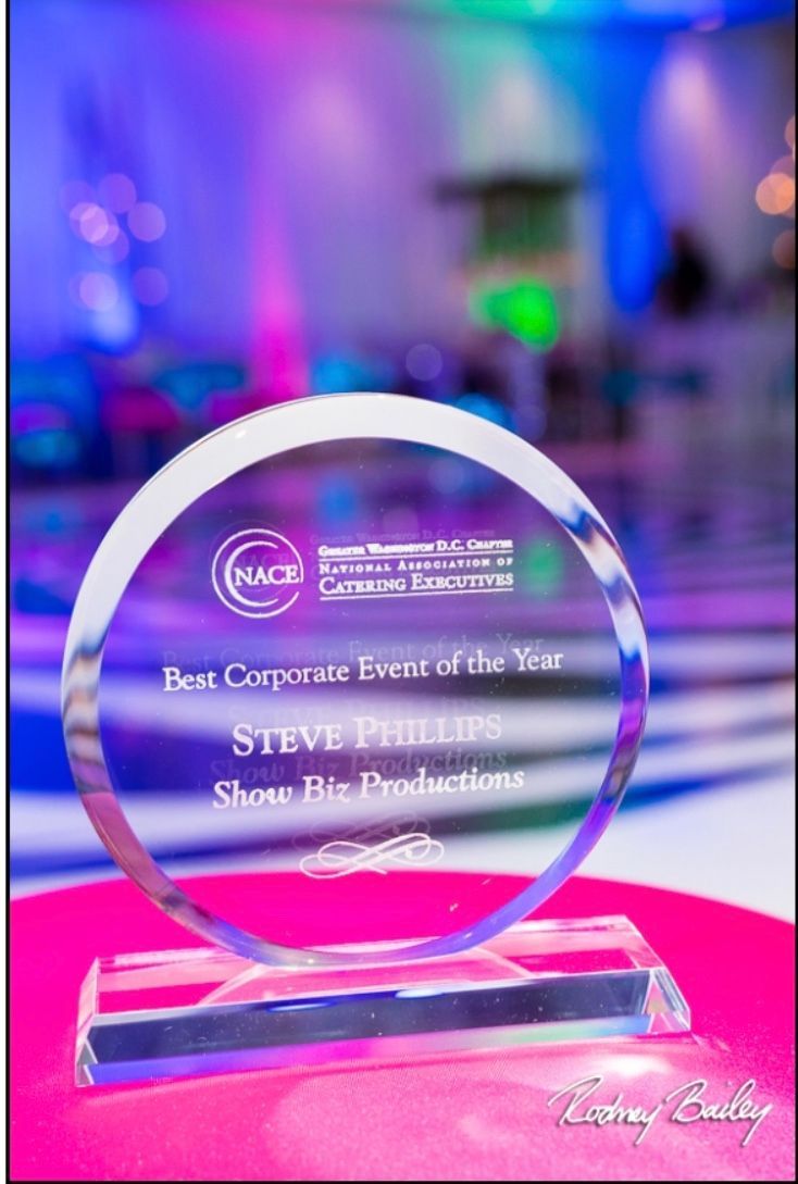 A glass trophy is sitting on top of a pink table.