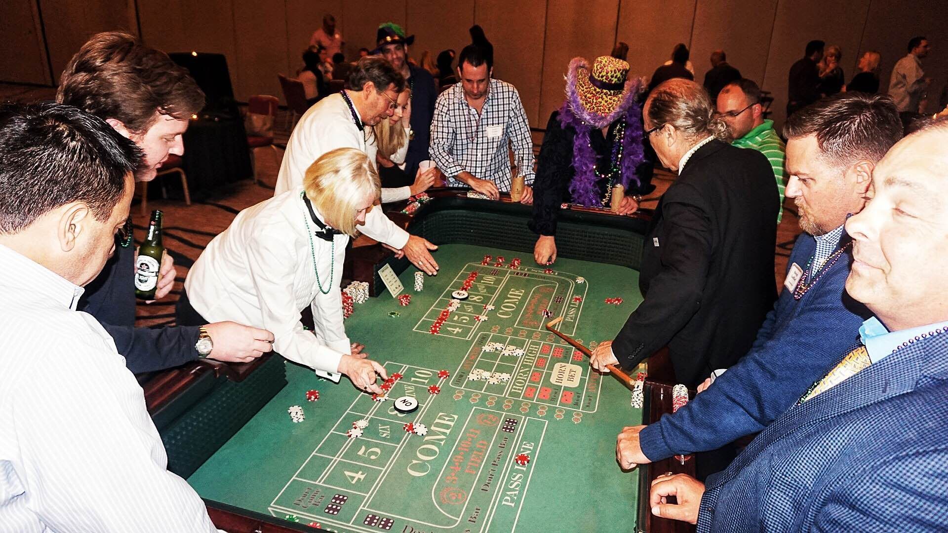 A group of people are playing roulette at a table.