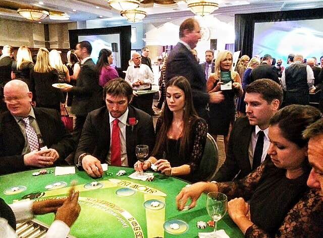 A group of people are playing a game of blackjack at a table.