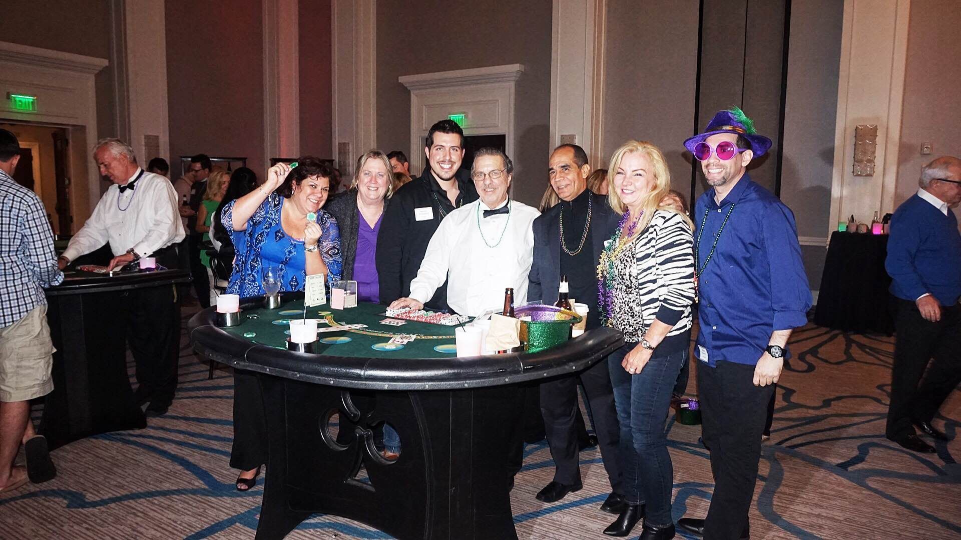 A group of people are standing around a table in a room.