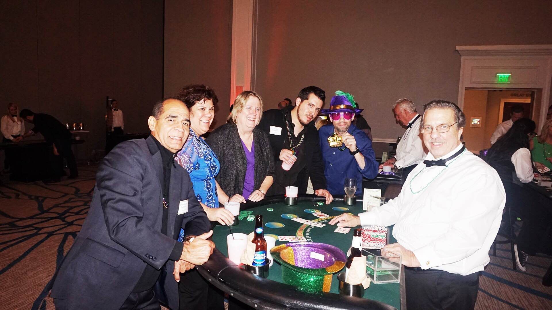 A group of people are sitting around a table playing poker.