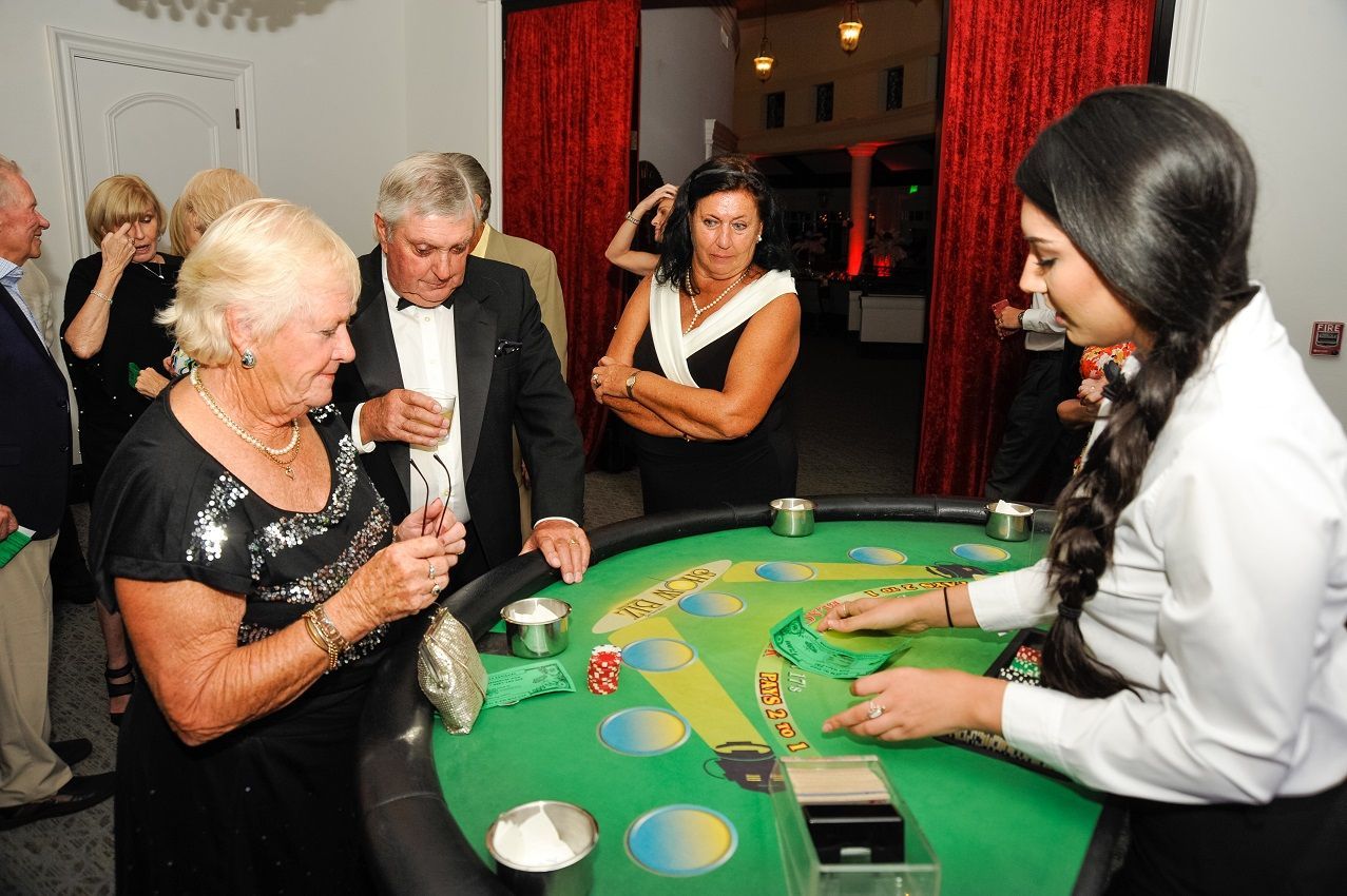 A group of people are playing a game of blackjack at a table.
