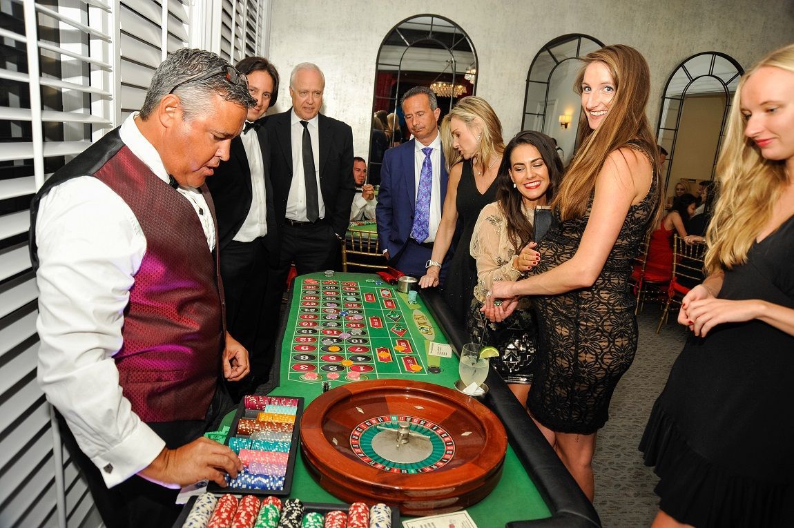 A group of people are playing roulette in a casino