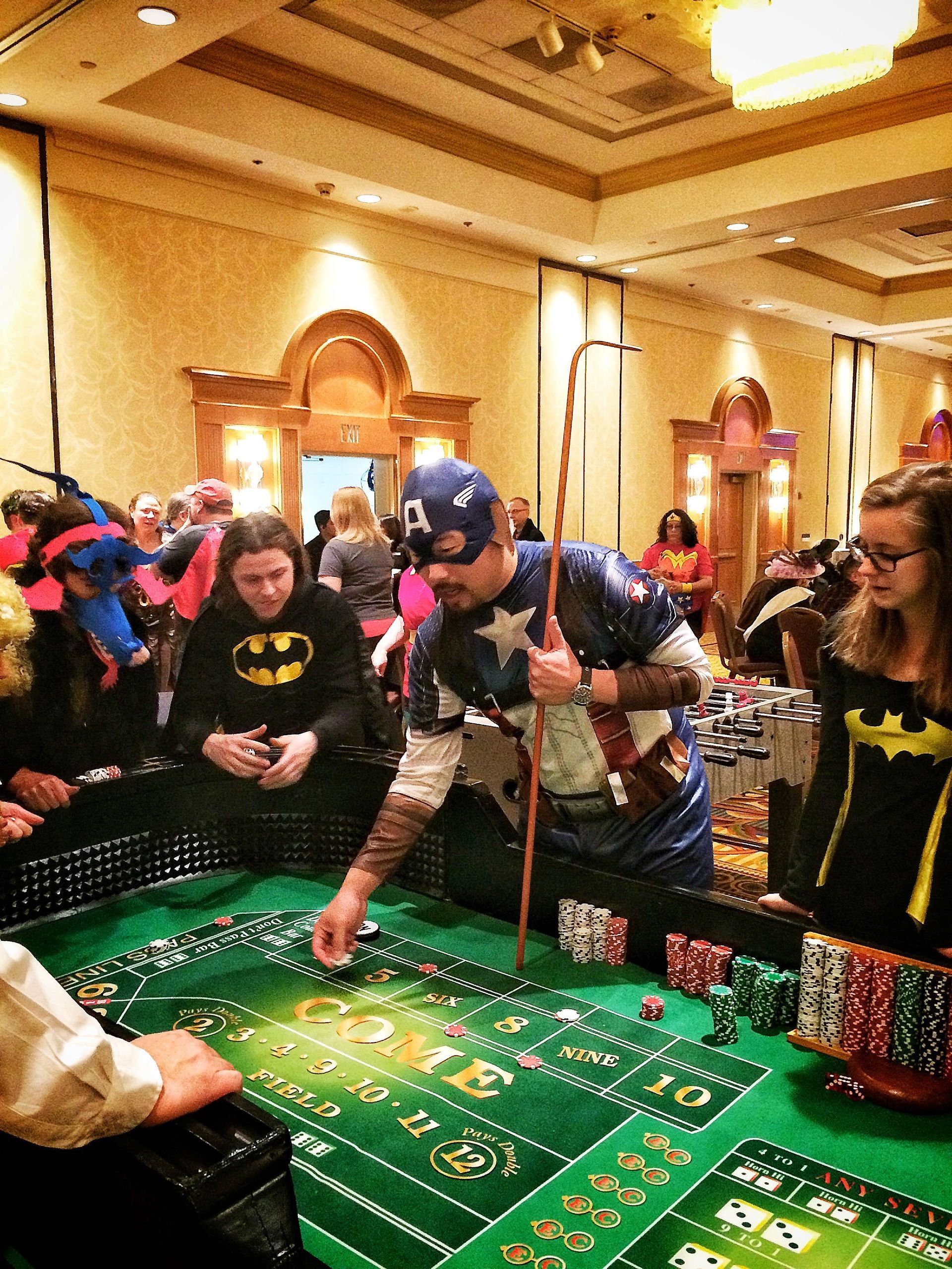 A group of people are playing roulette in a casino.