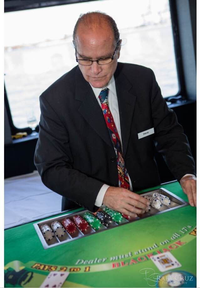 A man in a suit and tie is playing a game of poker