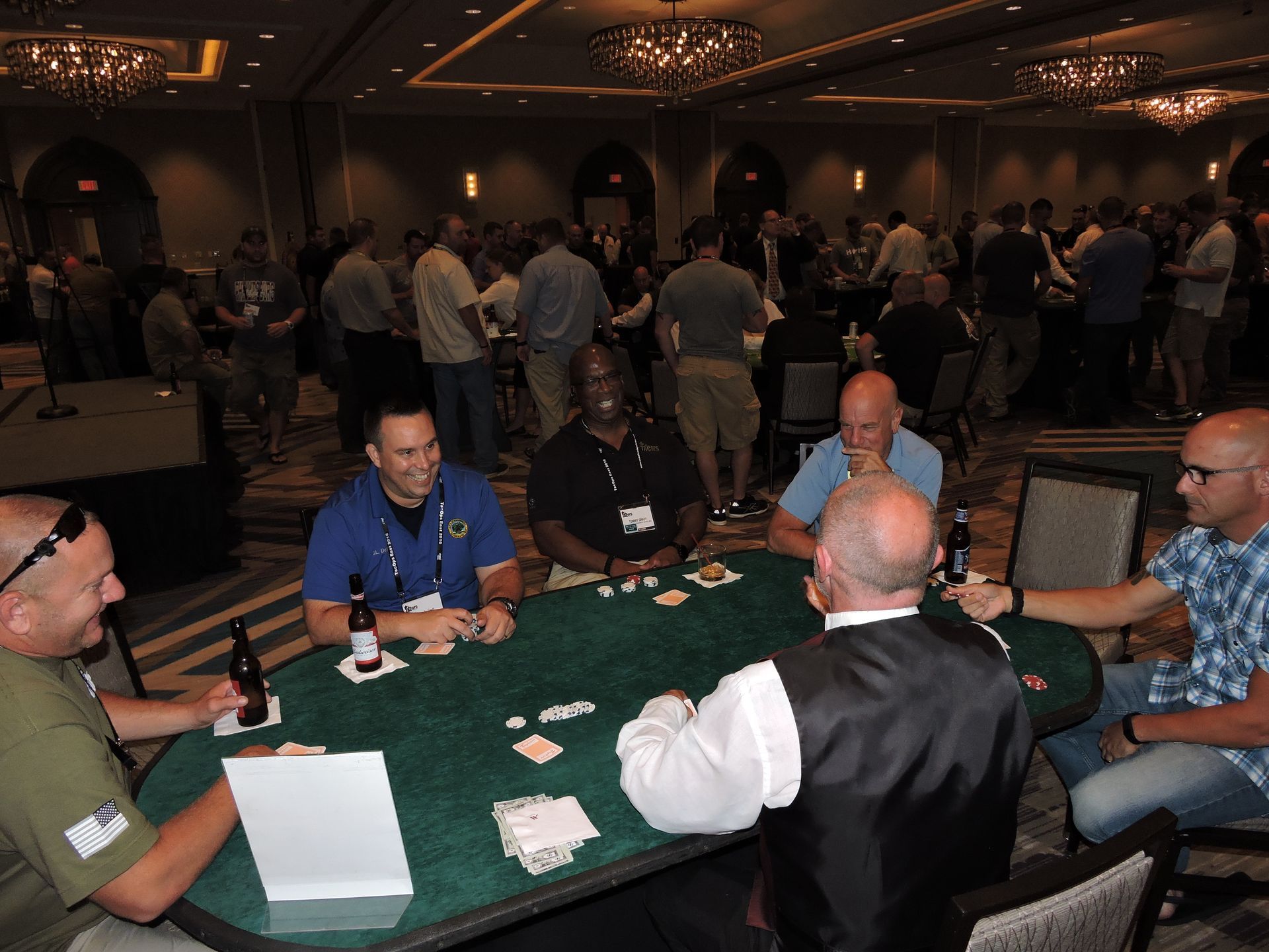 A group of men are sitting around a table playing poker.