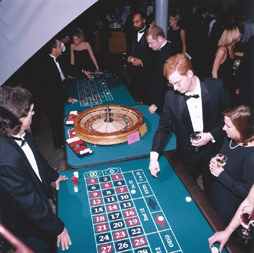 A group of people are playing roulette at a casino